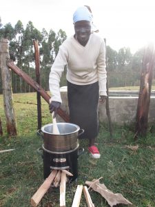 A woman in Kenya tests a more efficient cookstove developed by UW mechanical engineers and BURN Manufacturing.