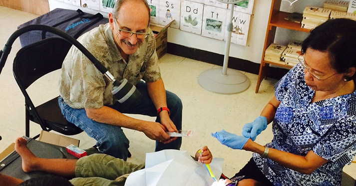 Dr. Peter Milgrom with patient and team