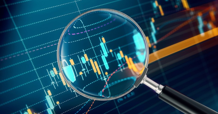 a magnifying glass held over data analysis graph