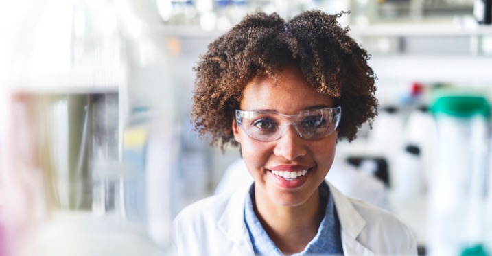 a scientist smiling in a lab